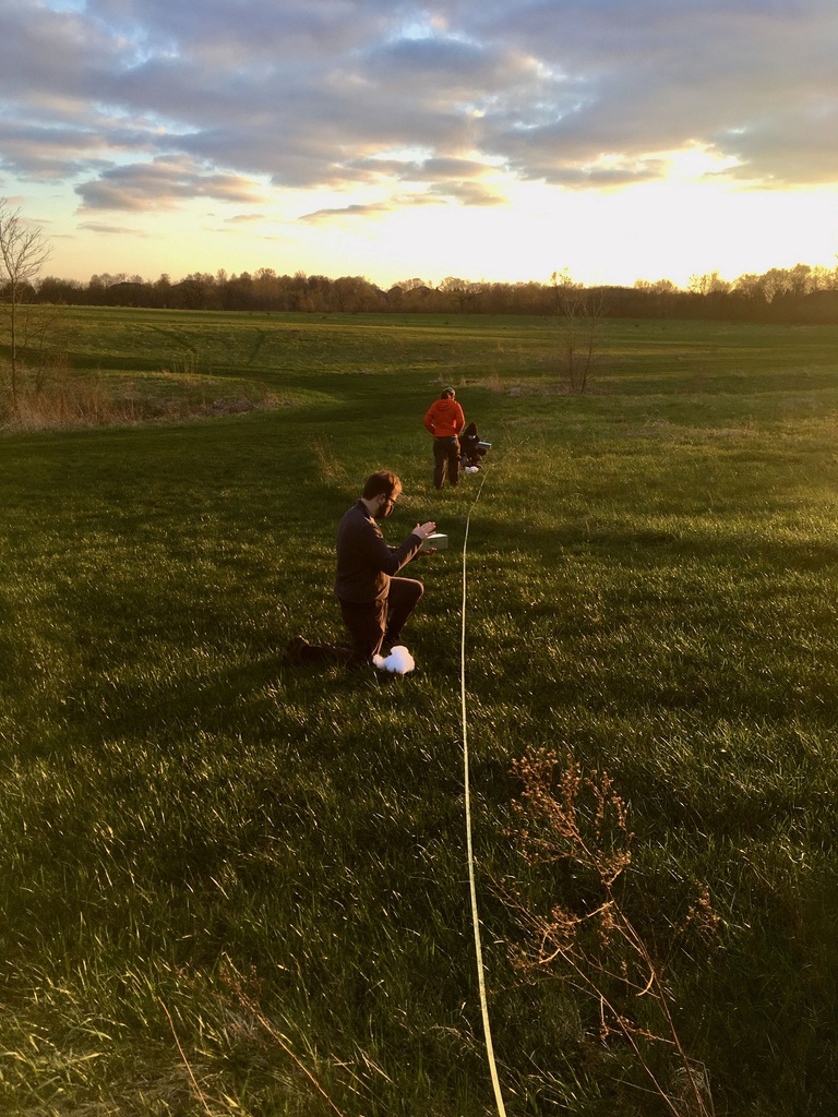 people surveying prairie 